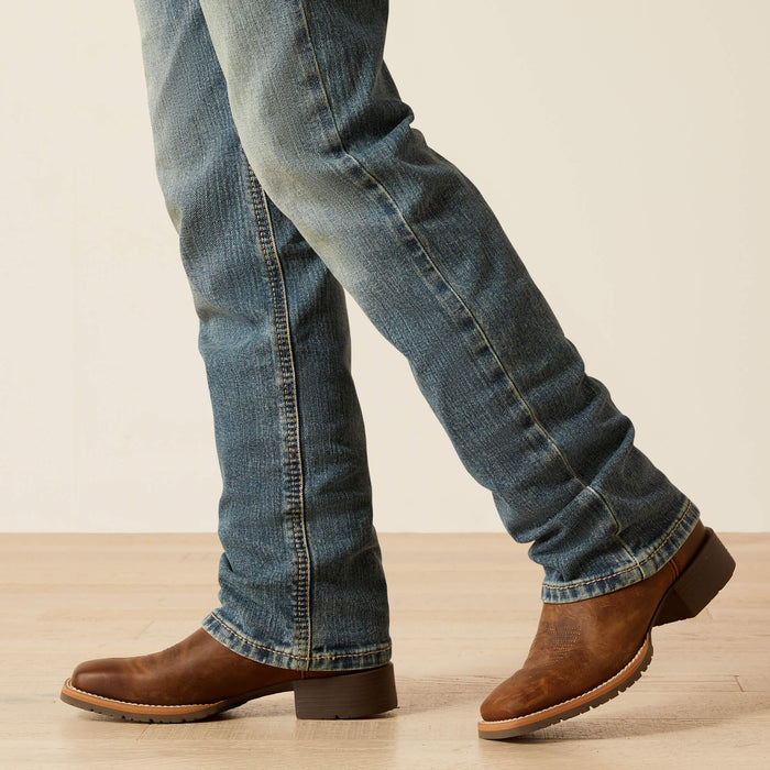 Boy's Ariat B5 slim straight jean in a medium wash. Bottom view showing leg opening.