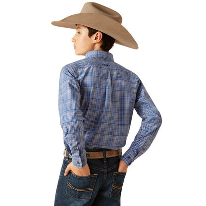 Boy's Ariat long sleeve shirt in True Blue Plaid. Rear view showing shirt tucked in and blocked Ariat logo on yoke.