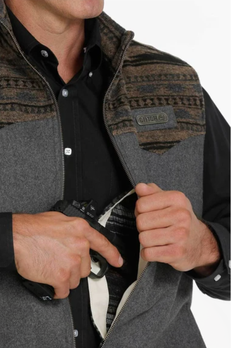 Cinch charcoal wooly conceal carry vest. Full front zipper. Partially unzipped view shows left chest inside conceal carry pocket.