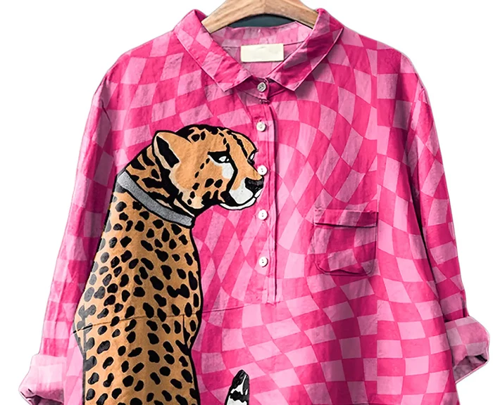 Pink checkered shirt with a leopard design on a hanger