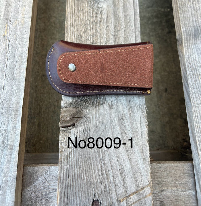 A Coffee Brown leather knife sheath with a embossed Longhorn and Star design. Rear view showing leather belt loop.